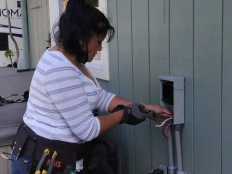 Licensed electrician wiring an exterior subpanel in Enfield